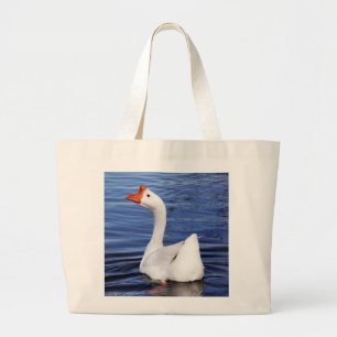 white swimming goose in blue water large tote bag