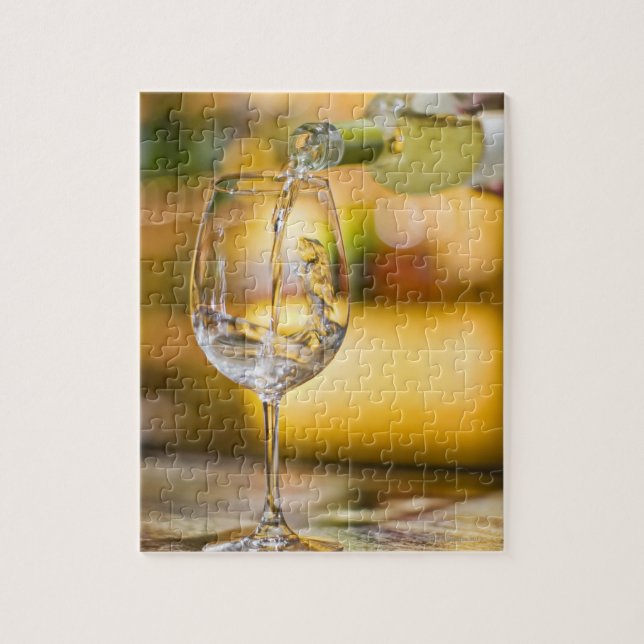 White wine is poured from bottle in restaurant. jigsaw puzzle (Vertical)