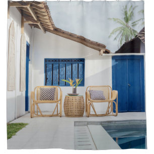Wicker table and two chairs near swimming pool