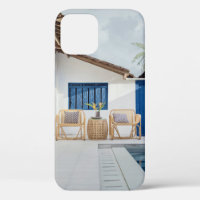 Wicker table and two chairs near swimming pool