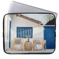 Wicker table and two chairs near swimming pool
