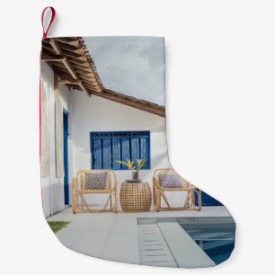 Wicker table and two chairs near swimming pool small christmas stocking