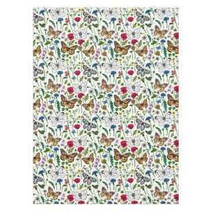 Wild flowers and butterflies on white tablecloth
