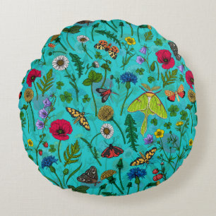 Wild flowers and moths on teal round pillow
