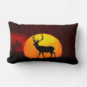 Wild reindeer silhouette & sunrise on a jungle lumbar pillow