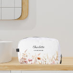 Wildflowers pink beige bridesmaid name dopp kit<br><div class="desc">White background,  decorated with wildflowers in pink and beige.  Personalize and add the name of your bridesmaid.</div>