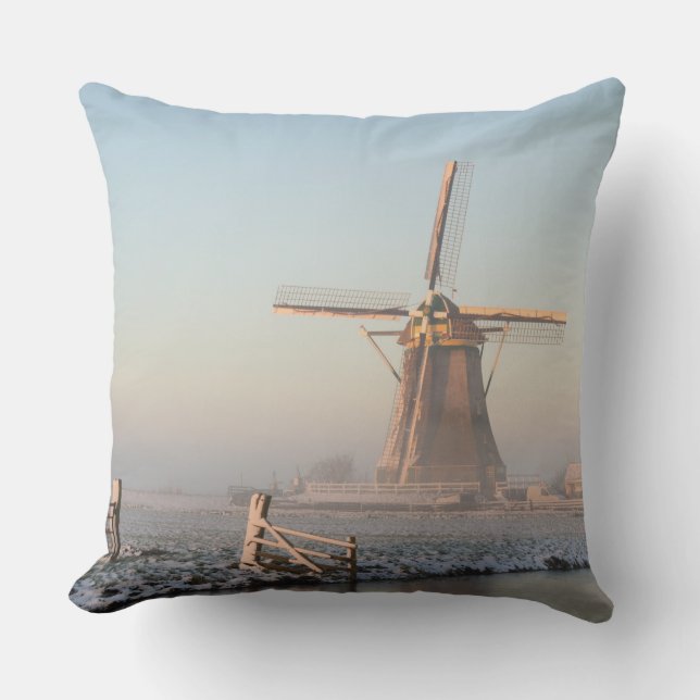 Windmill in the snow at sunrise throw pillow (Front)