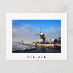 Windmill in the snow in a dutch winter landscape postcard