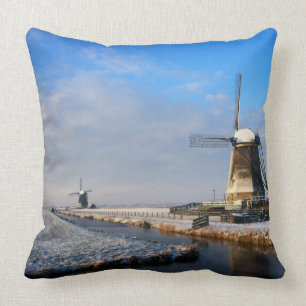 Windmill in the snow in a dutch winter landscape throw pillow