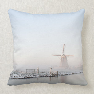 Windmill in the snow in winter throw pillow