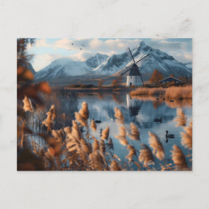 Windmill on a lake with mountains landscape postcard