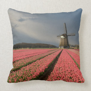 Windmill with pink tulips in spring throw pillow