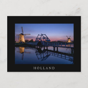 Windmills and drawbridge at sunset black postcard