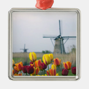 Windmills and tulips along the canal in metal ornament