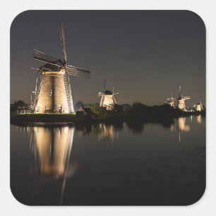 Windmills illuminated at night square sticker