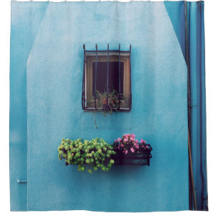 WINDOW WITH FRAME ABOVE GREEN AND PINK PETALED FLO