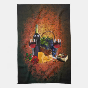 Wine glasses, bottle, grapes, cheese, chocolates kitchen towel