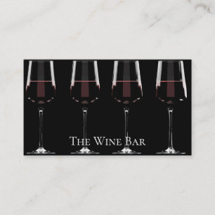 Wine glasses with red wine on black business card