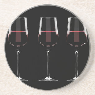 Wine glasses with red wine on black coaster