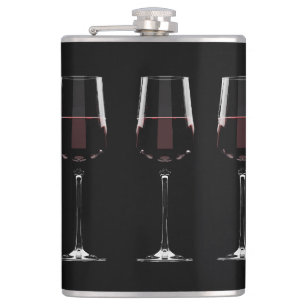 Wine glasses with red wine on black hip flask