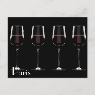 Wine glasses with red wine on black holiday postcard