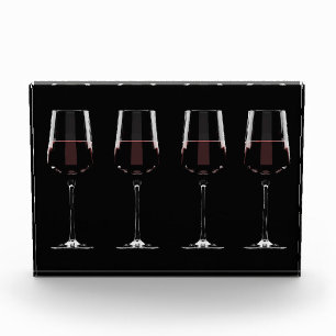 Wine glasses with red wine on black photo block