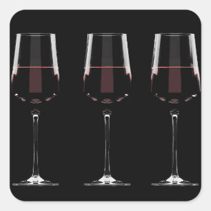 Wine glasses with red wine on black square sticker