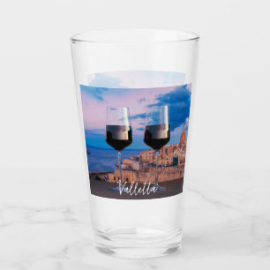 Wine glasses with view of sunset over Valletta
