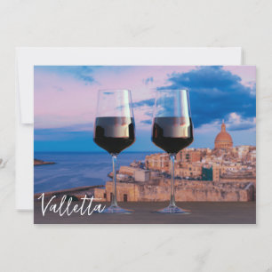 Wine glasses with view of sunset over Valletta