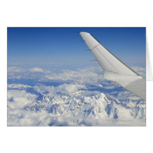 Wings of flying airplane over French Alps,