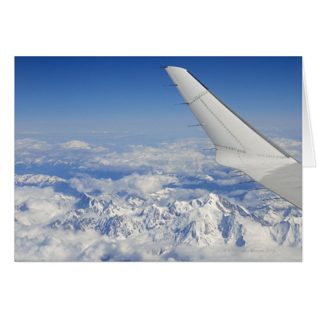 Wings of flying airplane over French Alps, (Front Horizontal)