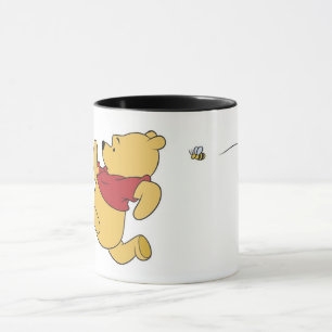 Winnie The Pooh chased by bee Mug