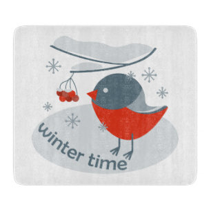 Winter bullfinch bird and red rowan berries cutting board