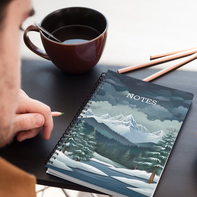 Winter Forest Scene Notebook (A snowy forest mountain scene notebook on a desk with pencils and coffee.)