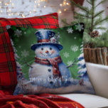 Winter Forest Snowman Christmas | Green Throw Pillow<br><div class="desc">Bring joy and whimsy to your seasonal decor with this charming Green Winter Forest Holiday Throw Pillow. Featuring a smiling snowman dressed in a classic top hat and cozy scarf, the design captures the magic of a wintry scene with softly falling snow and delicate white snowflakes. Nestled among frosted trees,...</div>