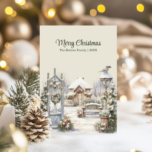 Winter Gate Christmas Card – Snowy Cottage Scene (Winter Gate Christmas Card – Snowy Cottage Scene on a table with Christmas decor and lights.)