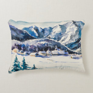 Winter landscape with mountain village covered wit accent pillow