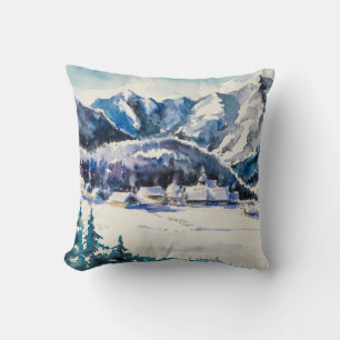 Winter landscape with mountain village covered wit throw pillow