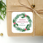 Winter Sprigs Wreath Merry Christmas Watercolor Square Sticker<br><div class="desc">This personalized holiday sticker features a watercolor wreath of green and red winter greenery,  including evergreen pine sprigs and holly leaves and berries. The words "Merry Christmas" appear in red serif font. Personalize the design with your family name below in green italics.</div>
