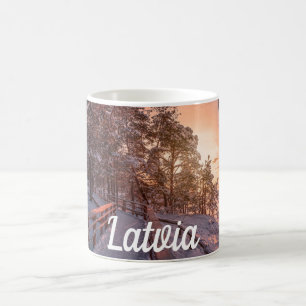 Winter sunset in pine forest near sea coffee mug