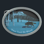 Winter Wolf - Tapetum Lucidum Oval Belt Buckle<br><div class="desc">A wolf walking on hard-crusted snow at night; a tree-covered peak in the background. Moonlight reflects off snow and pale bark of birch trees. The wolf's eyes also glow with reflected moonlight. Add your own text. The reflective quality of many animals eyes is due to the tapetum lucidum (Latin: "bright...</div>