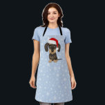 Wirehaired Dachshund Santa Teckel Christmas Dog Apron<br><div class="desc">Bring some canine Christmas cheer into the kitchen with this adorable holiday baking apron! The front features a large print cartoon-style drawing of a wirehaired dachshund wearing a bright red Santa hat atop its cute floppy ears. This adorable teckel apron is the perfect accessory for baking up batches of holiday...</div>