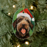 Wirehaired Pointing Griffon Christmas painting Ceramic Ornament<br><div class="desc">Colourful and joyful Christmas design with a Wirehaired Pointing Griffon wearing a Santa hat.</div>