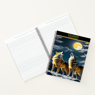 Wolves howl under a glowing moon notebook