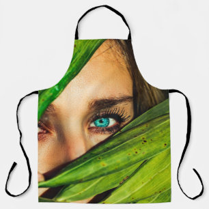 Woman behind green leaves apron