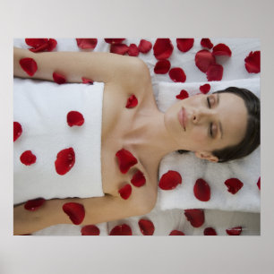 Woman covered in flower petals laying on massage poster