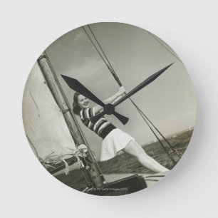 Woman Holding Rigging on Yacht Round Clock