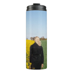 Woman in black coat standing on green grass field  thermal tumbler