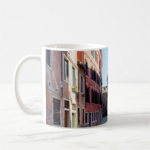 Woman in black jacket walking on sidewalk in the m coffee mug