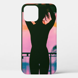 Woman in black tank top and pants standing on blac iPhone 12 case